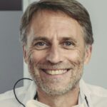 Dentist and patient smiling at camera, portrait