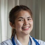 Smiling female doctor wearing a stethoscope in the doctor's office in the hospital